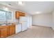 Kitchen features wood cabinets, white appliances, tile flooring, and natural light at 4326 Burrwood Dr, Indianapolis, IN 46235