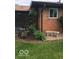 Exterior shot of the backyard with lush flowerbeds and comfortable outdoor seating at 4329 Dudley N Dr, Indianapolis, IN 46237