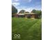 Well-maintained brick home with a lush green backyard and screened-in porch at 4329 Dudley N Dr, Indianapolis, IN 46237