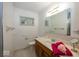 Bright bathroom featuring a wooden vanity, tiled floor, and a large mirror at 4329 Dudley N Dr, Indianapolis, IN 46237