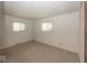 Neutral bedroom with two windows for natural light and wall-to-wall carpeting at 4329 Dudley N Dr, Indianapolis, IN 46237