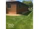 Brick house exterior with well-maintained lawn and gravel landscaping at 4329 Dudley N Dr, Indianapolis, IN 46237