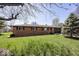 Charming single-story brick home featuring a well-manicured lawn and an attached garage at 4329 Dudley N Dr, Indianapolis, IN 46237