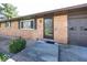 Brick home exterior with a well-kept lawn, featuring a side entrance and attached garage at 4329 Dudley N Dr, Indianapolis, IN 46237