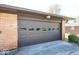 Garage door with decorative windows, brick exterior, and concrete driveway at 4329 Dudley N Dr, Indianapolis, IN 46237