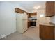 A kitchen with white appliances, wood cabinets, and neutral-colored walls at 4329 Dudley N Dr, Indianapolis, IN 46237