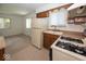 Kitchen featuring white appliances, wood cabinets, and natural light at 4329 Dudley N Dr, Indianapolis, IN 46237