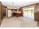 Open kitchen area featuring wood paneling, a gas range, a chandelier and sliding glass doors leading to the backyard at 4329 Dudley N Dr, Indianapolis, IN 46237