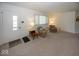 Cozy living room featuring neutral carpet, comfortable seating, and a bright front door at 4329 Dudley N Dr, Indianapolis, IN 46237