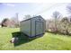 A backyard shed with neutral colored siding and a shingled gable roof at 4329 Dudley N Dr, Indianapolis, IN 46237