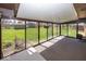 Bright sunroom with carpet flooring, multiple windows, and a view of the backyard at 4329 Dudley N Dr, Indianapolis, IN 46237
