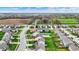 An aerial view of a neighborhood with well-manicured lawns, mature trees and a golf course in the distance at 4546 Creighton Ln, Indianapolis, IN 46237