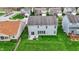 Aerial view of the home's back exterior with a patio and a lush green yard at 4546 Creighton Ln, Indianapolis, IN 46237