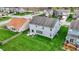 Aerial view of the home's back exterior with a stone patio and plenty of green lawn at 4546 Creighton Ln, Indianapolis, IN 46237