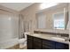 Well-lit bathroom featuring a double vanity, a shower-tub combo, and neutral decor at 4546 Creighton Ln, Indianapolis, IN 46237