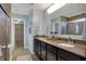 Bathroom featuring dual sinks with granite counters and a glass enclosed tiled shower at 4546 Creighton Ln, Indianapolis, IN 46237