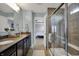Bathroom featuring dual sinks with granite counters and a glass enclosed tiled shower at 4546 Creighton Ln, Indianapolis, IN 46237