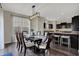 Bright dining area with a modern chandelier open to the kitchen with dark cabinetry at 4546 Creighton Ln, Indianapolis, IN 46237