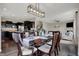 Open-concept dining room with modern light fixture, table set for a meal, and connected to the kitchen at 4546 Creighton Ln, Indianapolis, IN 46237