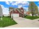 Charming two-story home with a brick facade, attached garage, and a basketball hoop at 4546 Creighton Ln, Indianapolis, IN 46237