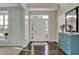 Bright foyer featuring hardwood floors, a decorative dresser, and a front door with sidelights at 4546 Creighton Ln, Indianapolis, IN 46237