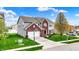 Charming two-story home with a brick facade, a well-manicured lawn, and a two-car garage at 4546 Creighton Ln, Indianapolis, IN 46237