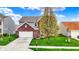 Charming two-story home with brick facade, attached two car garage, and well-manicured lawn at 4546 Creighton Ln, Indianapolis, IN 46237