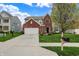 Charming two-story home with brick facade, attached two car garage, and well-manicured lawn at 4546 Creighton Ln, Indianapolis, IN 46237