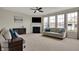 Bright living room features a fireplace, large windows, and a comfortable couch at 4546 Creighton Ln, Indianapolis, IN 46237