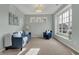Cozy living room with a large window, blue sofa and chair, and neutral carpet at 4546 Creighton Ln, Indianapolis, IN 46237