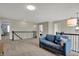 Spacious loft area with plush carpeting, comfortable seating, and natural light, perfect for relaxation and entertainment at 4546 Creighton Ln, Indianapolis, IN 46237