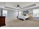 Spacious main bedroom with tray ceiling, ceiling fan, and ample natural light from many windows at 4546 Creighton Ln, Indianapolis, IN 46237