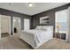 Well-lit main bedroom with a large bed, stylish decor, and attached bathroom at 4546 Creighton Ln, Indianapolis, IN 46237