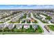 Aerial view of a neighborhood with winding streets, lush green lawns, and a small pond at 4546 Creighton Ln, Indianapolis, IN 46237