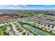 Aerial shot of a sprawling suburban neighborhood with houses, a pond, and a golf course at 4546 Creighton Ln, Indianapolis, IN 46237