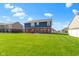 Spacious backyard showing lush lawn and patio area, great for entertaining or relaxation at 4638 W Otway Ln, New Palestine, IN 46163
