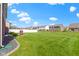 Spacious backyard with lush green grass and a white picket fence at 4638 W Otway Ln, New Palestine, IN 46163