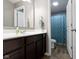 Bathroom with dark vanity and sink, mirror, and a shower with curtain at 4638 W Otway Ln, New Palestine, IN 46163