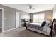This bedroom offers carpeted floors, a ceiling fan, and a window for natural light at 4638 W Otway Ln, New Palestine, IN 46163