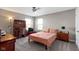 This bedroom has carpeted floors, a ceiling fan, and a study nook with desk at 4638 W Otway Ln, New Palestine, IN 46163