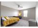 This bedroom has carpeted floors, a ceiling fan, and dresser with a lamp at 4638 W Otway Ln, New Palestine, IN 46163