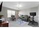 Inviting bonus room with comfortable seating, a flat-screen TV, and exercise bike at 4638 W Otway Ln, New Palestine, IN 46163