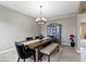 Elegant dining room featuring a rustic wood table, upholstered chairs, and a stylish chandelier, creating a perfect dining space at 4638 W Otway Ln, New Palestine, IN 46163