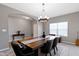 Open dining room showcasing a rustic wood table, chandelier lighting, and gray color scheme at 4638 W Otway Ln, New Palestine, IN 46163