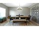 Dining room featuring a large table with bench seating, modern chandelier, and a decorative cabinet at 4638 W Otway Ln, New Palestine, IN 46163