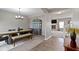 Stylish dining room featuring a farmhouse table, bench seating, and an elegant chandelier, perfect for Gathering meals at 4638 W Otway Ln, New Palestine, IN 46163
