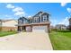 Gorgeous blue two-story home featuring a two-car garage, brick accents, and a well-maintained lawn in a lovely neighborhood at 4638 W Otway Ln, New Palestine, IN 46163