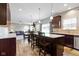 Bright, open kitchen with an island, dining area, and view into the cozy living room at 4638 W Otway Ln, New Palestine, IN 46163