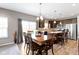 Modern kitchen with dark cabinets, stainless steel appliances, island seating, and access to the backyard at 4638 W Otway Ln, New Palestine, IN 46163