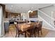 Open kitchen with dark cabinets, stainless appliances, granite counters, and an adjacent staircase at 4638 W Otway Ln, New Palestine, IN 46163